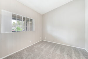 Interior Unit Bedroom, double window, neutral toned carpeting, neutral toned walls.